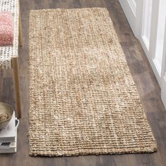 a rug on the floor next to a chair with a bowl in front of it