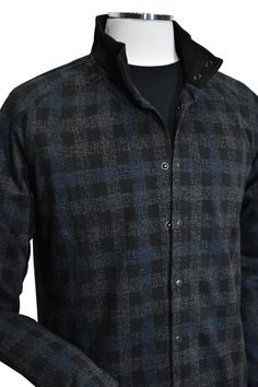 Introducing the Marcello Terrio Button Front Shacket, the perfect combination of style and functionality. This shirt jacket features a classic mock collar and snap enclosure, along with open sleeve cuffs and a waist band for a comfortable fit. The rich black base color is accented with a charcoal plaid pattern and a pop of royal blue. A mix of cotton, viscose and microfiber for a soft, light weight garment. Tubular cuffs and waist band add contemporary cool style. The model is perfect for a slim Modern Shirt With Placket For Fall, Modern Fall Shirt With Placket, Fall Shirt With Button Closure And Fold Down Collar, Modern Shirt With Button Cuffs For Fall, Modern Shirt With Buttons For Fall, Stand Collar Shirt With Buttons For Fall, Modern Fall Shirt With Button Cuffs, Fall Shirt With Stand Collar And Buttons, Modern Button Shirt For Fall