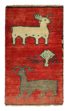 a red rug with animals on it and an animal in the middle of the rug