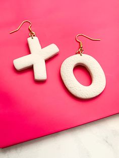 These X and O earrings are made of white polymer clay. Polymer clay is very lightweight, strong and flexible. They are hanging from a gold nickel free hypoallergenic hook. Size: 2.5 inch drop length These earrings are made and ready to ship. They are also available in pink or black. Pink: https://www.etsy.com/listing/1152352442/xoxo-earrings-valentines-day-earrings Black: https://www.etsy.com/listing/1152352546/black-xoxo-earrings-valentines-day Xoxo Earrings, Valentines Day Earrings, White Polymer Clay, Valentines Earrings, Clay Polymer, Chandler Az, Valentines Jewelry, Earrings White, Earrings Black