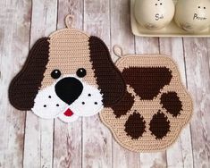 two crocheted dog coasters next to a cup of tea