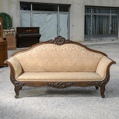 an old fashioned couch sitting in front of a building