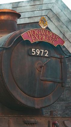 the hogwart's express sign is on top of an old steam engine train