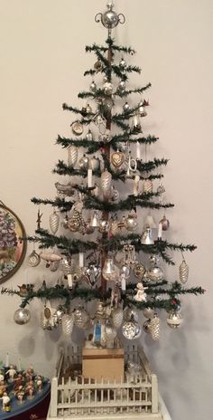 a small christmas tree with ornaments on it