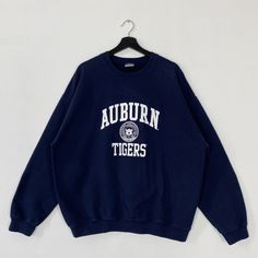 Vintage Auburn University Sweatshirt Auburn University Crewneck Auburn University Sweater Pullover Auburn Tigers Print Logo Blue XLarge 𝐁𝐫𝐚𝐧𝐝 :- Auburn University  𝐒𝐢𝐳𝐞 𝐓𝐚𝐠 :- XLarge Manual Measurement :- 𝐖𝐈𝐃𝐓𝐇 (armpit to armpit) :- 26 inches / 66cm 𝐋𝐄𝐍𝐆𝐓𝐇 (shoulder to end of garment) :- 27.5 inches / 70cm 𝐂𝐨𝐧𝐝𝐢𝐭𝐢𝐨𝐧 :- Good Condition 8/10.                      - No Hole, No Stain.                      - Colors Might Be Different Due To Lighting. - All items are VINTAGE which show some signs of wear and tear FEDEX EXPRESS = 3-6 business day arrived Collegiate Blue Letter Print Sweater, Blue Varsity Crew Neck Sweater, Blue Varsity Sweater For Fall, Blue Varsity Oversized Sweatshirt, Navy Letter Print Sweatshirt For Fall, Blue Oversized Varsity Sweatshirt, Blue College Style Long Sleeve Sweatshirt, Blue Long Sleeve Varsity Sweater, Blue Winter College Style Sweatshirt