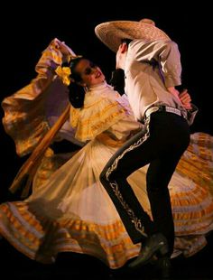 a man and woman are dancing on stage