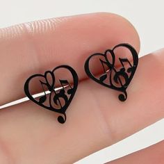 Unique Music Notes And Treble Clef In A Heart Black Stud Earrings. Perfect For Any Musician Or Music Lover. Also Available In Gold Toned, Rose Gold Toned And Silver Toned. 27b Black Heart Earrings As A Gift, Black Heart Earrings For Pierced Ears As Gift, Black Metal Heart Earrings, Black Metal Earrings For Valentine's Day, Black Valentine's Day Earrings, Black Earrings For Valentine's Day, Black Music-themed Jewelry For Gift, Music-themed Black Jewelry Gift, Treble Clef Heart