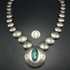 "VINTAGE NAVAJO NECKLACE DESCRIPTION: This fabulous necklace features hand-stamped graduated round pillow beads and a center pendant with turquoise cabochon on one side and storyteller images on the reverse. Curved sterling silver end cones at the terminals. This exciting necklace will be a valuable addition to your collection of fine vintage Native American jewelry. MEASUREMENTS: Necklace measures 24\" end to end Central pendant measures 1 7/8\" across Pillow beads measure from 16mm to 24mm acr Stamped Turquoise Round Jewelry, Turquoise Stamped Round Jewelry, Stamped Round Turquoise Jewelry, Antique Stamped Turquoise Jewelry, Collectible Round Turquoise Necklace, Bohemian Stamped Round Pendant Jewelry, Adjustable Vintage Silver Turquoise Necklace, Vintage Adjustable Silver Turquoise Necklace, Vintage Turquoise Stamped Jewelry