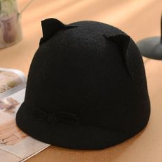 a black cat hat sitting on top of a table