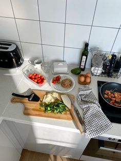 the kitchen counter is cluttered with food and utensils