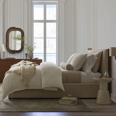 a bedroom with a bed, dresser and mirror in it's centerpieces