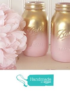 pink flowers and two mason jars sitting on a table