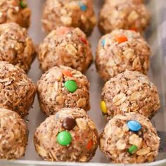 a metal tray filled with lots of cookies and candies on top of each other