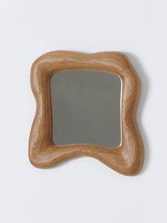 a wooden frame with a mirror on the top and bottom part, in front of a white background