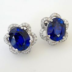 Dazzling! Absolutely Stunning Kashimir Blue Oval Sapphire 12.07ct, White Pave Sapphires Sterling Silver Floral Earrings. 17mm Approx Length. #Uniquegifts #Giftsforher #Mothersday #Finejewelry #Designerjewelry #Floralearrings #Bluesapphire *Earrings-165* Formal Blue Earrings With Prong Setting, Blue Prong Set Earrings For Formal Occasions, Blue Prong-set Earrings For Formal Occasions, Elegant Blue Round Cut Earrings, Elegant Blue Diamond Cut Earrings, Gia Certified Sapphire Earrings For Formal Occasions, Elegant Tanzanite Earrings With Brilliant Cut, Blue Fine Jewelry Earrings For Formal Occasions, Elegant Blue Earrings With Prong Setting