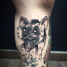 a close up of a person's leg with a tattoo on it and an animal