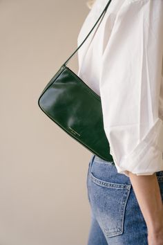 Meet a petite, on-the-go edition of our best-loved baguette bag. An easy-to-carry little number at a perfectly accessible price point. Vegan Leather Zip at top Lined Shoulder bag with golden-tone hardware Length 24.5cm, Width:4.5cm, Height 11.5cm Weight:200g Shipping & Return Free US shipping on orders over $100.Free International shipping on orders over $300. For more details click HERE. Shoulder Bag Leather Woman, Green Baguette Bag, Green Leather Bag Outfit, Purse With Outfit, Green Leather Purse, Wedding Guest Handbag, Green Leather Shoulder Bag, Green Shoulder Bag Outfit, Architect Bag