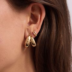 The epitome of understated elegance, these sleek sculptural gold hoops have a two-in-one impact, with an equally lightweight sensibility to them. Chic Yellow Gold Huggie Earrings, Modern Gold-tone Huggie Earrings, Modern Hoop Earrings With Gold-tone Hardware, Elegant Gold-tone Hoop Huggie Earrings, Gold Chic Huggie Earrings For Formal Occasions, Modern Plated Hoop Earrings, Modern Gold-tone Huggie Earrings For Pierced Ears, Chic Gold Huggie Earrings, Chic Gold-plated Huggie Earrings