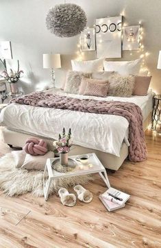 a white bed sitting on top of a wooden floor