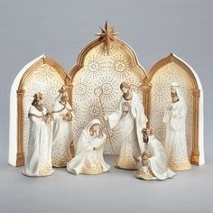 a group of figurines in white and gold