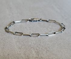 A nice understated paperclip bracelet that you can wear everyday. Made entirely out of sterling silver you have your choice of an oxidized finish or not, and clasp. ~ Solid Sterling Silver a.k.a. 925 Silver ~ 3 Finishes Available ~ Link size: 4.3mm X 10mm My go to info on how to choose a bracelet size: https://maisygracedesigns.com/apps/help-center Please note if ordering the dark oxidized finish that with handling and time the oxidation will wear away in places, giving the bracelet more of a li Paperclip Bracelet, Silver Chain Style, Silver Chain Bracelet, Necklace Length, Chain Link Bracelet, Paper Clip, Bracelet Sizes, Cute Jewelry, Earring Necklace