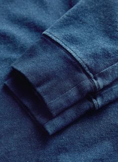 a close up view of the pocket on a pair of dark blue jeans, folded and unbuttoned