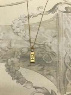 "Simple, yet stately!  This 14K gold necklace has a small, cute gold bar pendant and diamond accent where the bail meets the bar.  Stamped 14KT on pendant.  18\" chain.  We are obsessed with this vintage piece! Measurements: 18\" chain .5\"L x .25\"W bar pendant Weight: 2.4 grams" Classic Yellow Gold Bar Necklace With Rectangular Pendant, Classic Yellow Gold Rectangular Bar Necklace, Classic Hallmarked Necklace With Rectangular Pendant, Classic Gold Rectangular Bar Necklace, Classic Rectangular Gold Bar Necklace, Antique Gold Necklace With Rectangular Pendant, Classic Gold Bar Necklace Engraved, Classic Gold Engraved Bar Necklace, Classic Yellow Gold Charm Necklace With Rectangular Pendant