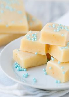 several pieces of cake on a plate with blue sprinkles