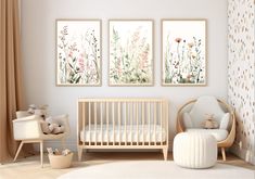 a baby's room with three paintings on the wall