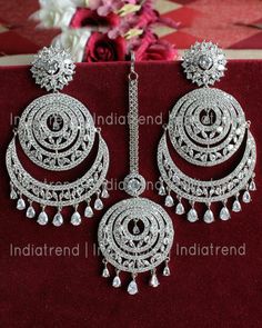 Bollywood traditional ethnic fashion Bridal party wear zircon stones and American Diamond clear crystal rhinestone dangle earrings and maang tikka lady wedding jewellery. Earrings lock is press or post type. Silver Plated drop earrings jewellery can be used on marriage,engagement,birthday and any occasion. Care Tip - 1. Keep away from moisture and perfume 2. Store in cotton or zip lock bags or air tight boxes. 3. Spot cleaning only. 4. Jewellery is the last thing you should wear and the first th Indian Jewelry Design, Maang Tika, Rose Gold Earrings Studs, Fancy Jewellery Designs, Chandbali Earrings, Indian Jewellery Design Earrings, Jhumki Earrings, Maang Tikka, Indian Jewellery Design