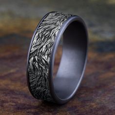 a wedding band that has been made to look like an intricate pattern on the inside of it