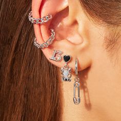 a close up of a person's ear with two different earrings on top of it