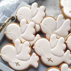 decorated cookies in the shape of doves and crosses