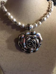 This necklace created by Jewelry By CARMAL is made of a silver plated flower pendant, mother of pearl gemstones, silver plated: daisy spacers, lobster claw clasp and findings. This necklace measures 20 inches in length and the pendant is 1 3/4 inches. View more beaded necklaces: http://www.etsy.com/shop/jewelrybycarmal?section_id=7999556 WE OFFER FREE STANDARD SHIPPING WITHIN THE UNITED STATES. All of our jewelry is unique and custom designed. We would love to assist you with any custom orders o Metal Flower Shaped Jewelry For Anniversary, Flower Shaped Costume Jewelry Necklace For Wedding, Flower Shaped Wedding Costume Jewelry Necklace, Elegant Beaded Flower-shaped Jewelry, Metal Jewelry With Flower Pendant For Wedding, Wedding Necklaces With Flower Charm In Metal, Wedding Necklace With Flower Charm In Metal, Elegant Metal Flower Necklace For Wedding, Pearl Jewelry With Flower Decoration For Gift