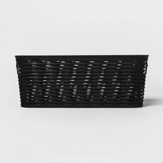 a black basket sitting on top of a white surface