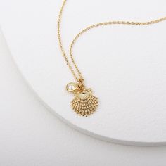 Gold clam shell pendant with tiny pearls inspired by the beautiful ocean world Clams symbolize luck, and give off gentle healing energies, which help in balancing and harmonizing your aura. Please keep the necklace dry and take care in stock after used. Soft and simple. great for gift, everyday or special occasion. Material : Brass, Simulated Pearl Pendant : 13mm x 16mm Pearl : 5mm Ocean-inspired Pearl Charm Jewelry As Gift, Ocean-inspired Pearl Charm Jewelry For Gifts, Ocean-inspired Pearl Charm Jewelry Gift, Shell-shaped Pearl Pendant Jewelry Gift, Shell-shaped Pearl Pendant Jewelry For Gift, Pearl Pendant Shell Jewelry Gift, Pendant Shell Necklace With Lobster Clasp As Gift, Pearl Pendant Jewelry In Shell Shape As A Gift, Ocean-inspired Pendant Charm Necklace As Gift