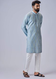 Editor's Note The light blue kurta with multicolor thread and pants is a vibrant and eye-catching ensemble. The kurta features a light blue color with intricate multicolor threadwork, adding a pop of color and texture to the overall design. It is complemented by matching pants, creating a coordinated and stylish look. Fabric: Cotton silk Color: Blue Components: Kurta and pants Occasion: Festive Note: Product colour may slightly vary due to photographic lighting sources Care: Dry clean only About Blue Cotton Silk Kurta For Spring, Bollywood Style Dabka Sherwani For Spring, Spring Designer Wear Blue Sets, Bollywood Dabka Sherwani For Spring, Designer Spring Blue Set, Spring Light Blue Sets With Resham Embroidery, Blue Anarkali Kurta For Transitional Season, Multicolor Cotton Silk Kurta With Dabka Detail, Blue Cotton Silk Straight Kurta