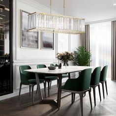 a dining room table with green chairs around it