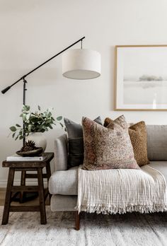 a living room filled with furniture and a lamp