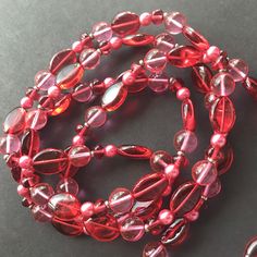 ON SALE Vintage red pink long fashion glass beaded necklace in excellent vintage condition. Measures 44 inches long. Red Long Beaded Necklaces For Party, Red Single Strand Beaded Necklace For Party, Red Long Beaded Necklace For Party, Long Red Beaded Necklaces For Parties, Vintage Red Beaded Necklaces For Party, Elegant Pink Beaded Necklaces With Oval Beads, Elegant Red Long Necklace With Round Beads, Runway Jewelry, Desert Hot Springs