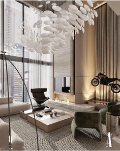 a living room filled with furniture and a motorcycle hanging from the ceiling