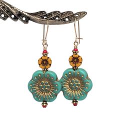 "Large, colorful Anemone flower earrings in a retro shades of aqua and marigold.  Detailed, European pressed-glass flower beads are matched with tiny, vintage, ruby red seed beads.   22K gold-plated spacers add texture to a look which is lively and fun. Quality 14K gold-filled ear wires - choose from kidney or French.  14K gold-filled head pins.  Length is 1 7/8\". All my Etsy jewelry offerings are designed and created by me.  As an independent craftsperson, I value your patronage.  Please use c Vintage Turquoise Flower Earrings, Vintage Turquoise Dangle Flower Earrings, Turquoise Nickel Free Flower Earrings, Nickel Free Turquoise Flower Earrings, Vintage Multicolor Czech Glass Earrings, Handmade Turquoise Flower-shaped Earrings, Vintage Gold Earrings With Colorful Beads, Handmade Vibrant Gold Earrings, Vibrant Handmade Gold Earrings