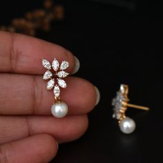 A bunch of beautiful natural white hand picked marquise and tear drop diamonds, arranged neatly to form a triangle, with a beautiful light pink pearl dangling from the center render the design in a way that your heart will surely skip a beat.. Ours did.. :) * Diamond Wt. : 1.05 Cts (Marquise + Pear) approx * Color-Clarity Grade : Near Colorless, Vs-Si Purity * Gold - 14k, 3.28 gms rose gold An exclusive piece from our shop, these earrings are absolutely to die for..! Special Earrings for your sp White Bridal Earrings With Diamond Accents, Pear-shaped, Diamond Earrings With Pearl Drop As Gift, Diamond Earrings With Pearl Drop For Gift, Diamond Pearl Drop Earrings As Gift, Gift Diamond Earrings With Pearl Drop, Marquise Diamond Jewelry With Matching Earrings, White Diamond Cluster Earrings Marquise Shaped, White Pear-shaped Diamond Earrings For Wedding, Pear-shaped Rose Cut Diamond Earrings For Wedding