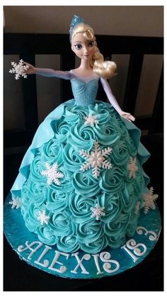 a barbie doll cake with blue frosting and snowflakes