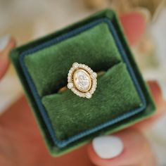 a diamond ring in a green velvet box