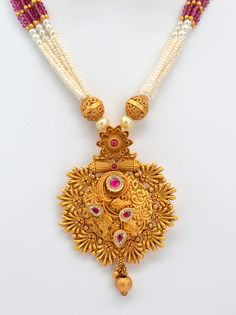 This beautiful antique gold pendant features Kemp stones and American diamonds, paired with a Pearl Mala Necklace and earrings set. This exquisite necklace enhances your style for any occasion, adding sparkle whether you wear it with a dress or a stunning saree. Necklace Length: 11.5" and can be adjusted with a chain. Earring length: 1.5" with push-back closure Antique gold Polish and High-quality brass as the base metal Availability: In-Stock. *Color may vary slightly due to light condition & p Yellow Gold Pendant Temple Necklace For Wedding, Yellow Gold Temple Necklace Pendant For Wedding, 22k Gold Temple Necklace Pendant For Wedding, 22k Gold Wedding Temple Necklace Pendant, Wedding 22k Gold Temple Pendant Necklace, Diwali Temple Jewelry Sets With Pendant, 22k Gold Chandbali Temple Necklace For Celebration, Yellow Gold Kundan Pendant Necklace For Wedding, 22k Gold Temple Necklace With Chandbali Shape For Celebration