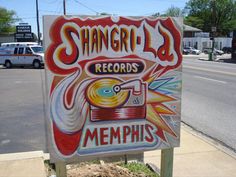 a sign on the side of a road that says shangro's records