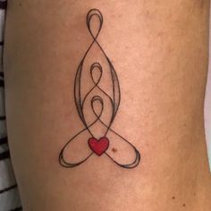 a woman's thigh with a tattoo on it and a heart in the middle