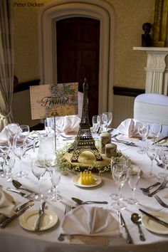 the table is set with wine glasses, silverware and place settings for an event