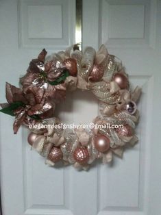 a white door with a pink and gold wreath on it